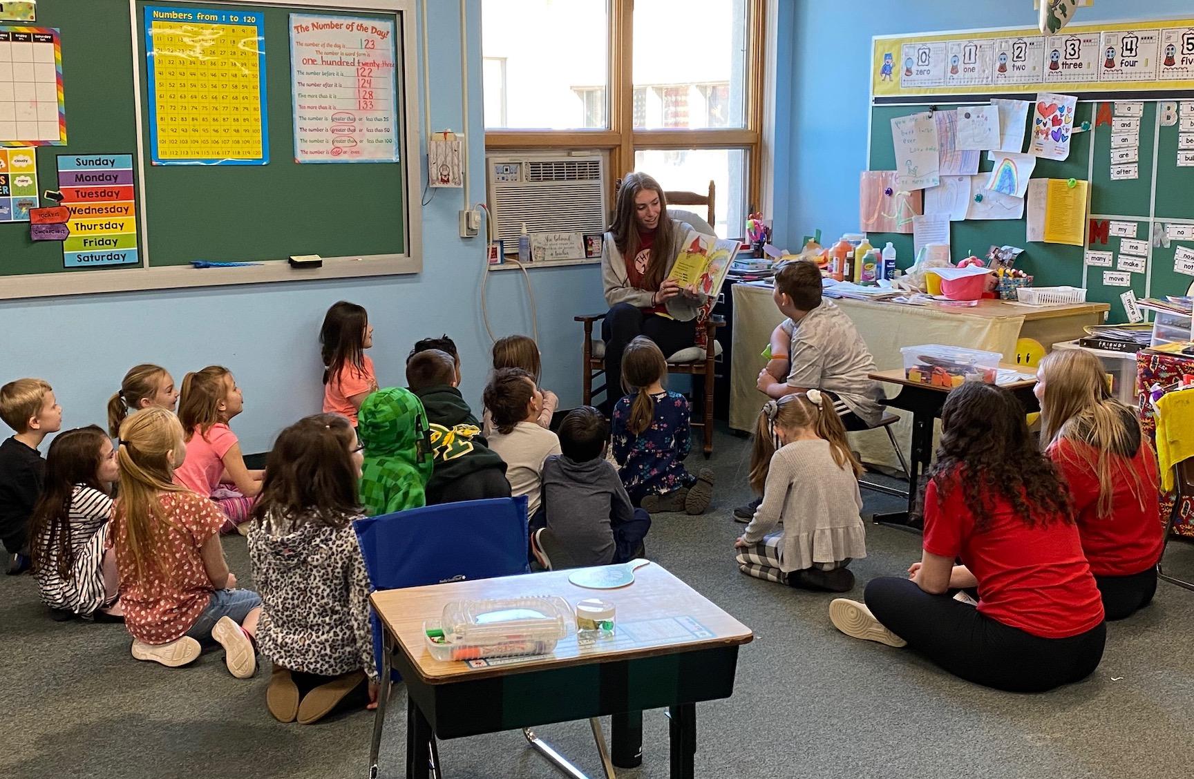 media intern reads to an elementary class
