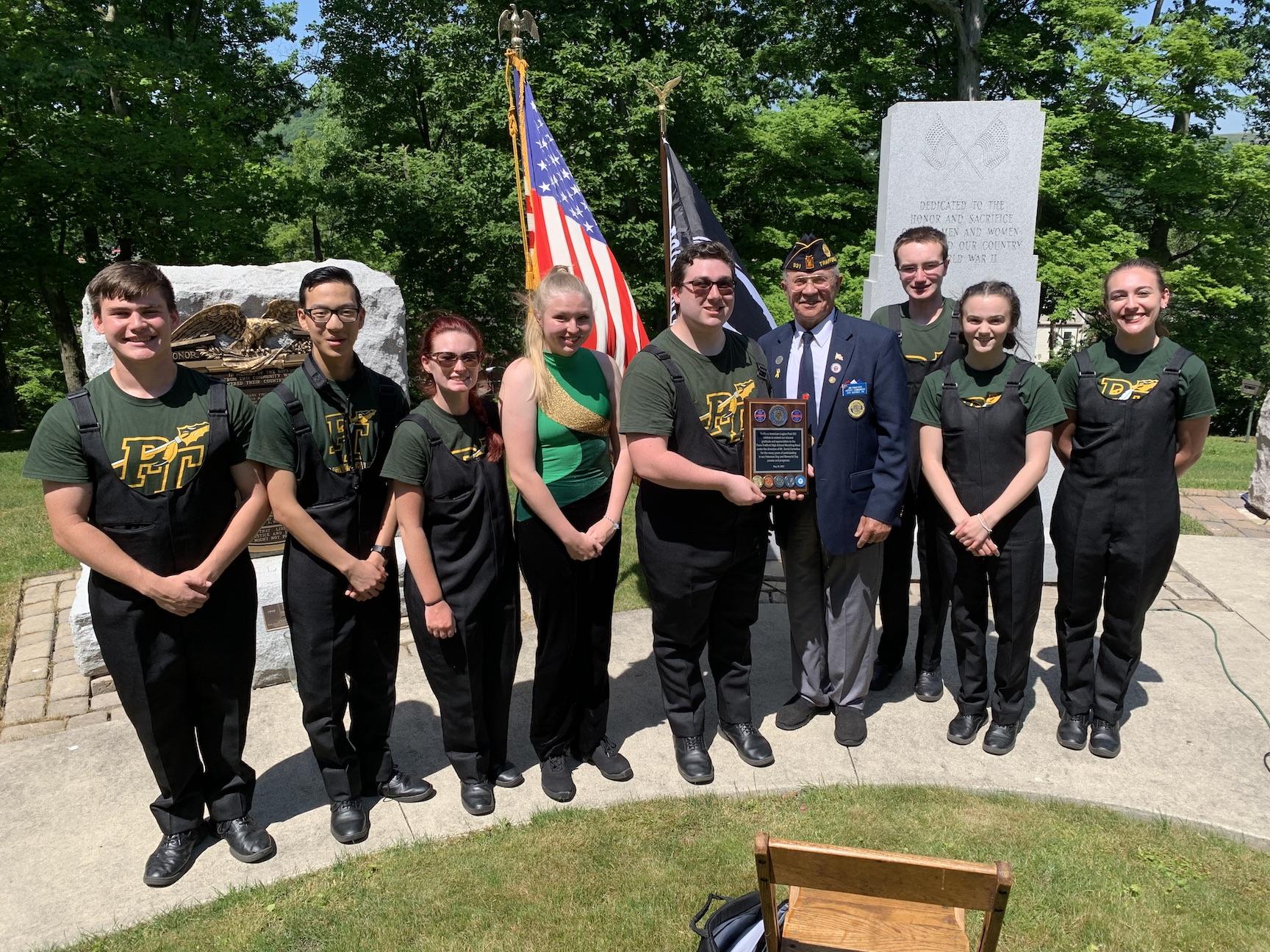 American Legion Post 331 commander, Jim Drnjenich, presented a plaque to the graduates of the Penn-Trafford Marching Band in appreciation for many years of participation
