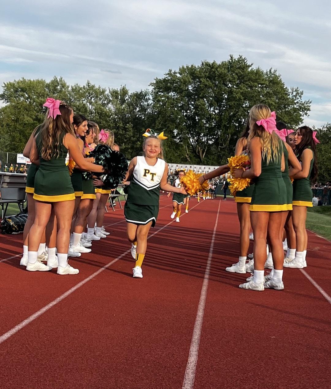 First-grade midget cheerleader Gianna Capoccioni runs down the sideline