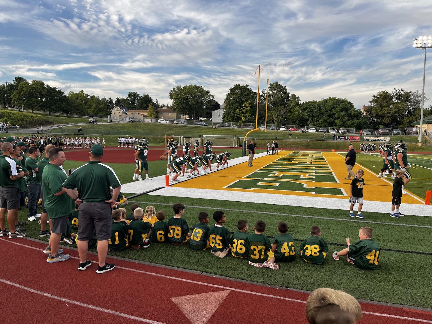 The midget football teams were able to observe warm-ups from a great vantage point