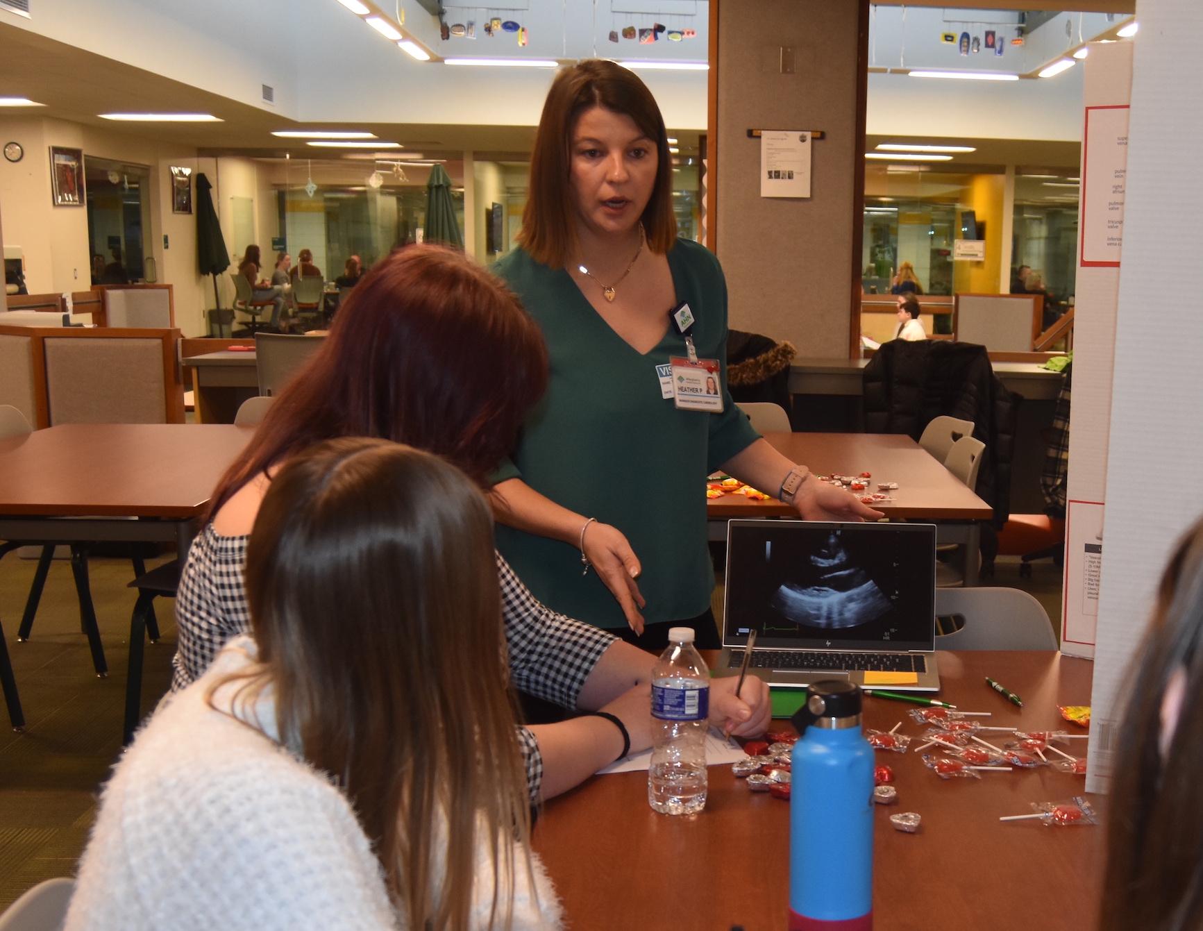 Heather Patton-Csuhta, a manager of diagnostic cardiology, speaks to a small group of students