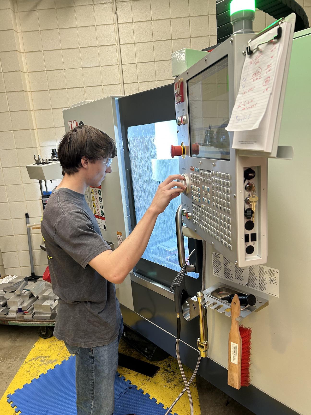 Michael Koreen, a senior at Penn-Trafford High School, operates the Haas CNC mill