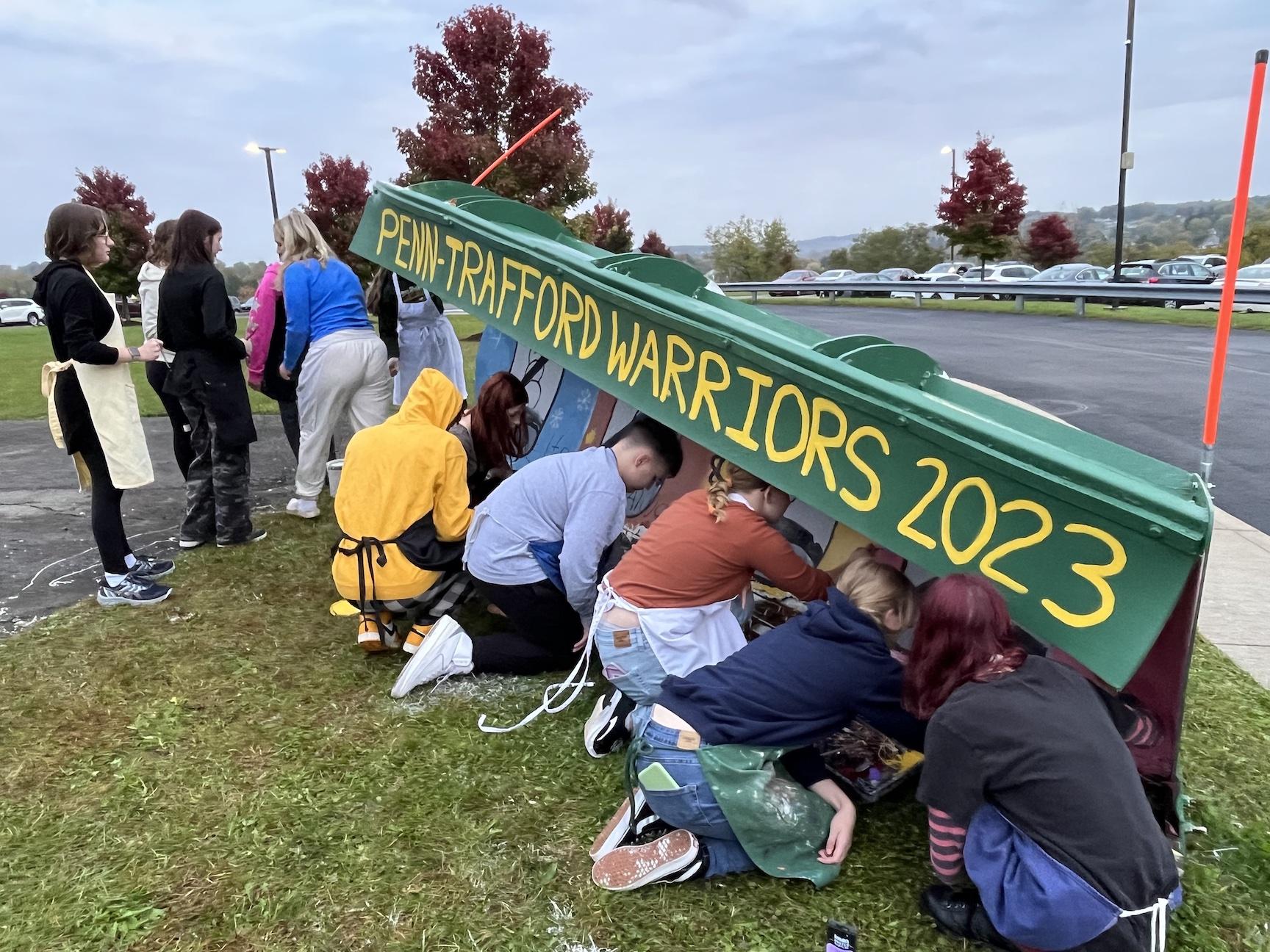Students work together on painting the plow