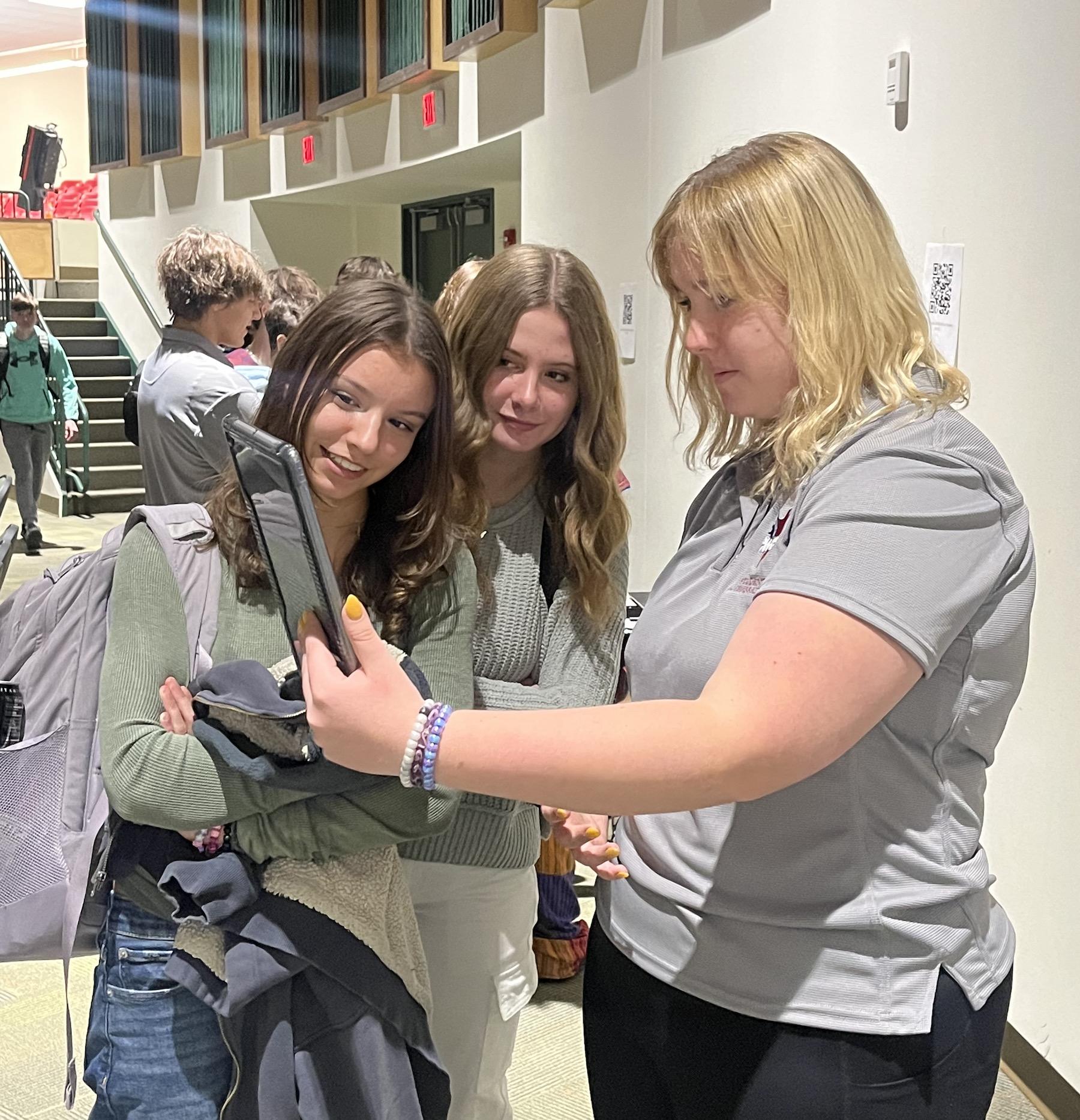 12th-grader Savannah Palazzo (right) shares a healthcare demo with some freshmen