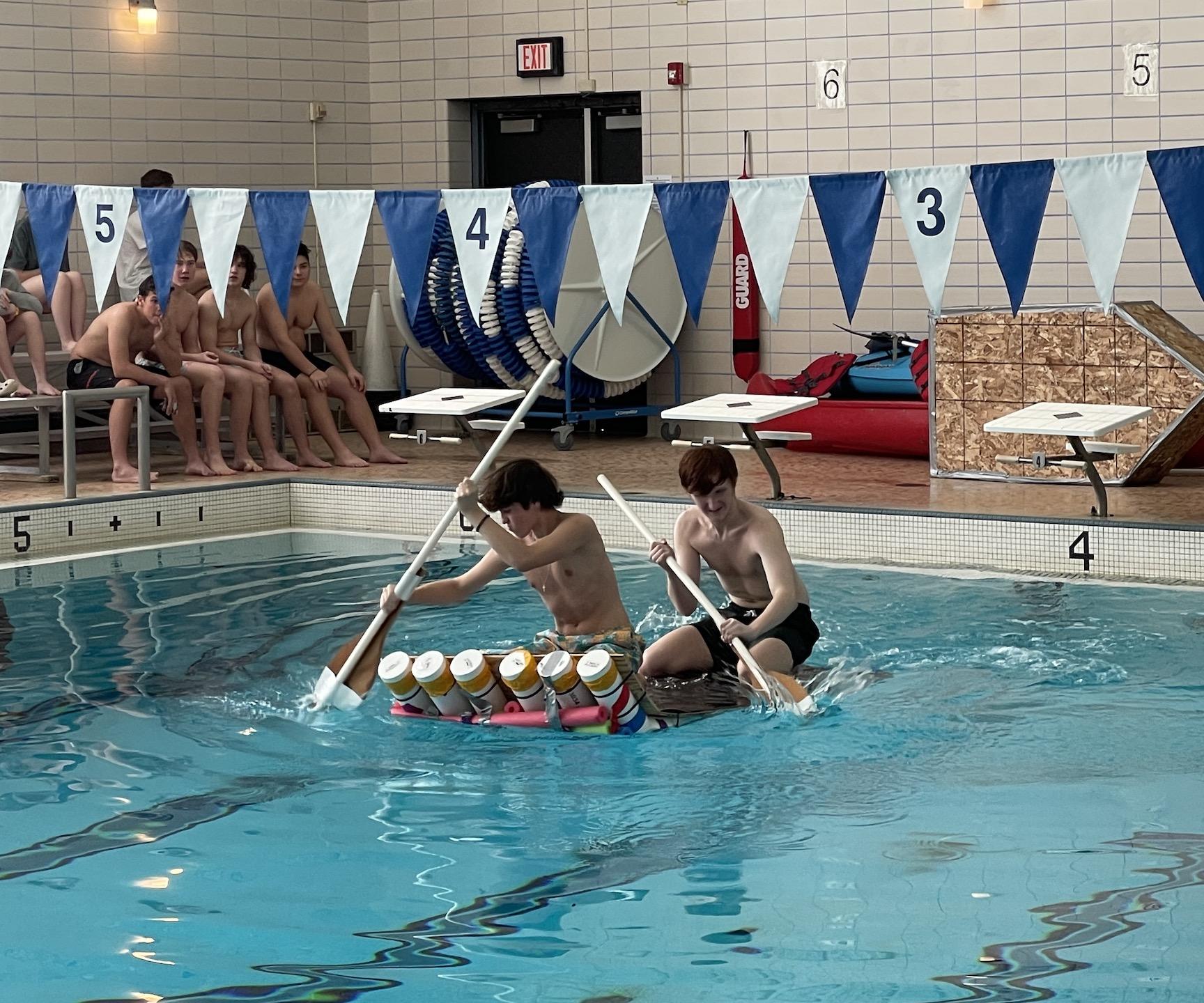 Tim Wolford and Spencer Slacker paddle Team One’s raft across the pool